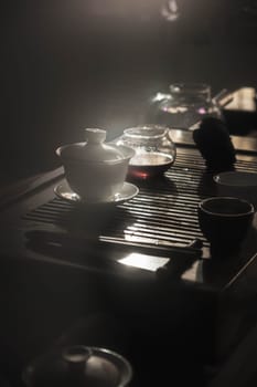 A serene tea setup with delicate teapots and exquisite cups, beautifully arranged and gently illuminated