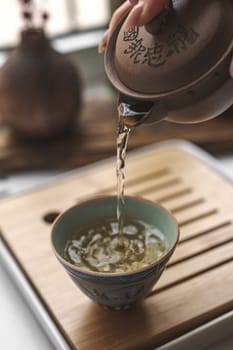 A beautifully serene moment as tea is gently poured into a delicate cup, showcasing both tradition and tranquility