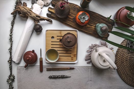 A serene arrangement of tea accessories with exquisite pottery, bamboo, and natural decor for a tranquil atmosphere
