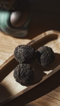 A calming composition of textured dark objects artfully arranged on wood, evoking a strong nature connection