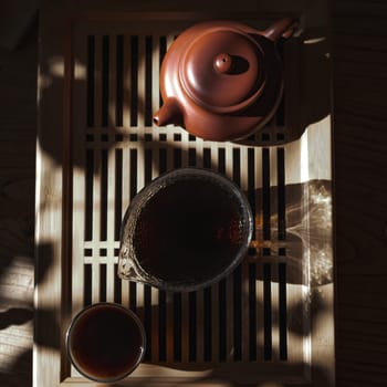 A serene tea setup with a fine pot, elegant pitcher, and cozy cup of tea, all in soft, warm sunlight