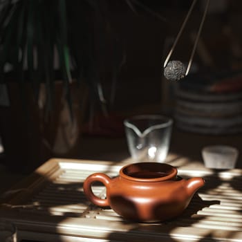 A serene scene with a crafted teapot and tea scoop, embodying the essence of tea preparation and enjoyment