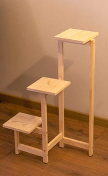 Close up shot of assembled wooden shelf for plants in pots
