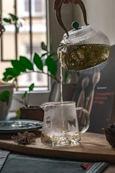 A serene scene of fragrant tea elegantly poured into a glass pitcher, capturing a perfect tea moment