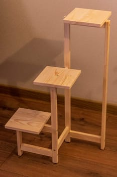 Close up shot of assembled wooden shelf for plants in pots
