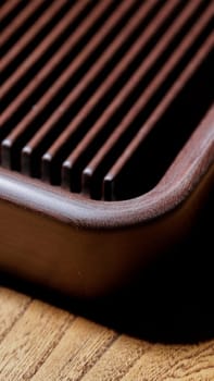 Closeup view of a stylish wooden serving board showcasing deep grooves, perfect for food presentation