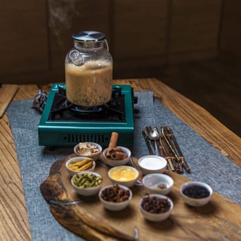Dive into the delightful art of brewing chai tea, infused with aromatic spices, in a warm and cozy atmosphere