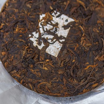 Experience the enchanting allure of a finely aged Puerh tea cake, offering unique flavors and rich textures
