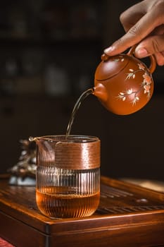 A tranquil and serene moment beautifully captures the elegant art of pouring tea from a lovely teapot