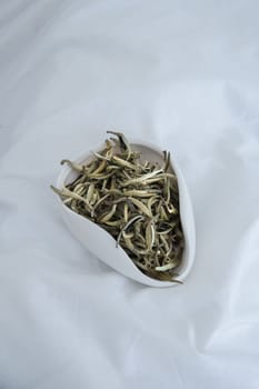 A vibrant closeup image showcases dried small fish artfully displayed in a sleek, modern white serving dish