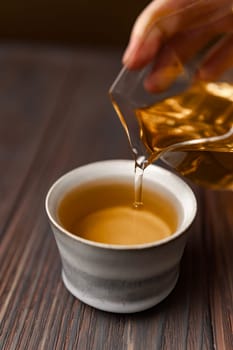 A serene moment of tea being poured into a classic cup, showcasing the beauty of simplicity and comfort