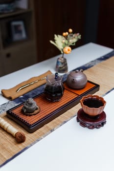 A serene tea setup with a traditional tea set and a floral centerpiece that enhances the atmosphere
