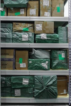 Shelves meticulously organized and filled with wrapped media stock packages that are ready for distribution purposes