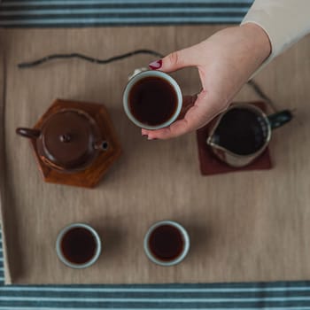 Immerse yourself in the exquisite art of tea with a calming setup that highlights a beautiful teapot and cups