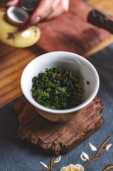 A calming view of vibrant green tea leaves displayed in a traditional cup, ideal for passionate tea lovers