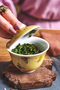 This is an aesthetic capture of a serene tea ceremony, beautifully showcasing vibrant and refreshing green tea leaves