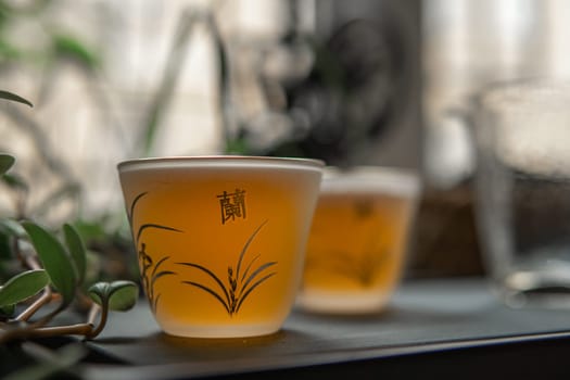 Aesthetic tea cups filled with fragrant herbal tea, surrounded by vibrant lush greenery, evoking a sense of tranquility