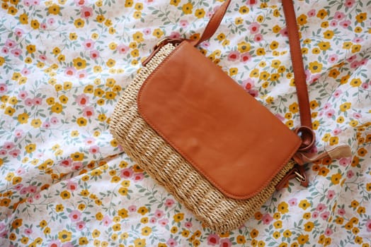 This stylish woven handbag featuring a chic leather flap is perfect for all your summer outings