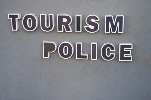 A signboard indicating tourism police services available for visitors to the area