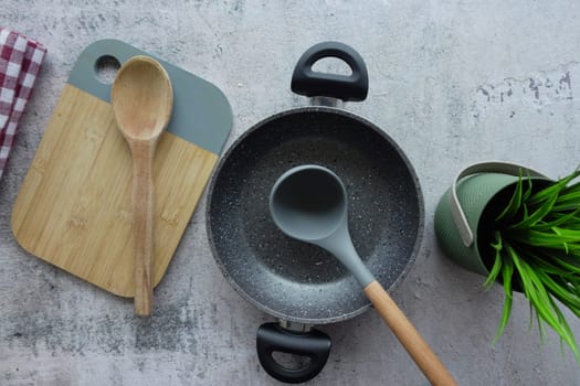 A beautifully designed minimalist kitchen scene that features various cookware and utensils