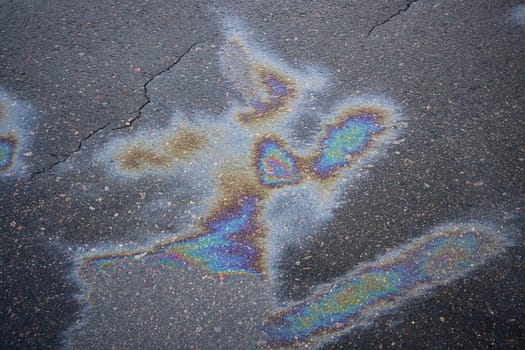 Striking oil spill displaying bright colors on the asphalt surface