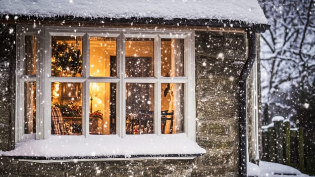 Christmas in the countryside, cottage decorated for holidays on a snowy winter evening with snow and holiday lights, English country styling inspiration