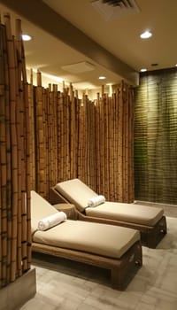 Tranquil spa room features bamboo furniture and soft ambient lighting, creating a serene atmosphere for relaxation and rejuvenation. designed with ultimate comfort in mind, this space enhances wellness with natural elements.