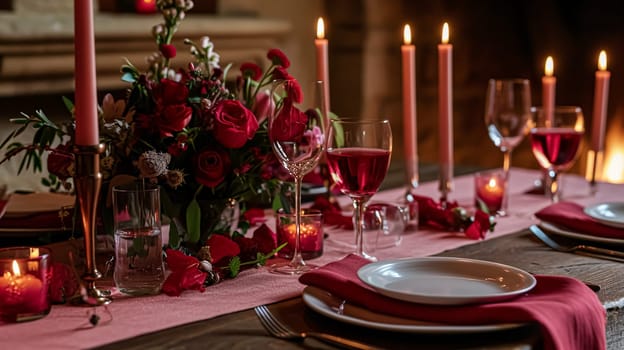 Festive table setting with candles and arrangement of beautiful red flowers. Holiday concept. High quality photo
