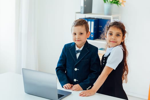 Boy With Girl Schoolchildren With Laptop At School