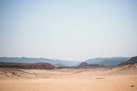 Image of the desert and mountains on the Sinai Peninsula at sunset. The Sinai Desert is an attraction accessible to vacationers of all resort areas of Charm. excursion in Egypt. Tourist attraction