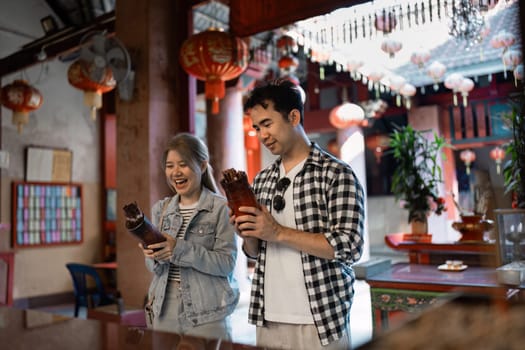 A joyful couple explores unique cultural artifacts in a vibrant marketplace the spirit of travel and discovery.