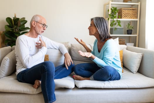 Mature married couple having an argument. Woman is angry with man. Relationship and divorce concept.