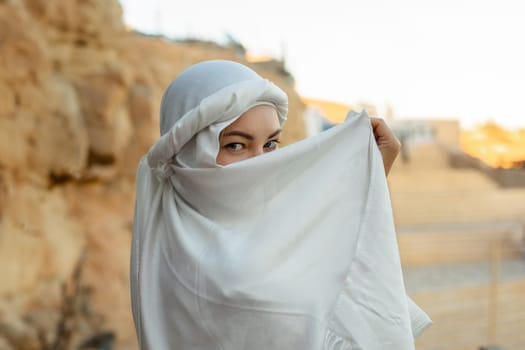 Portrait of a beautiful woman in Arabic clothing in Egypt during sunset
