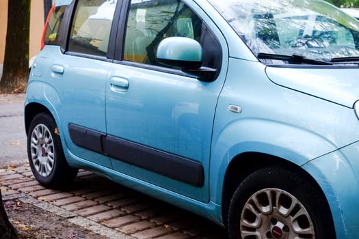 Cremona, Itally - October 6th 2024 Light blue fiat panda 1.2 lounge parked gracefully on a peaceful street next to a lively tree, showcasing contemporary european flair in a tranquil cityscape