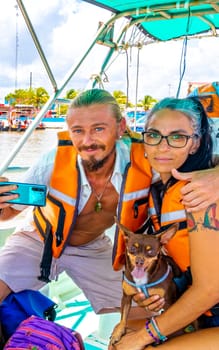 A handsome couple travels with life jackets on boat in Chiquila Lazaro Cardenas in Quintana Roo Mexico.