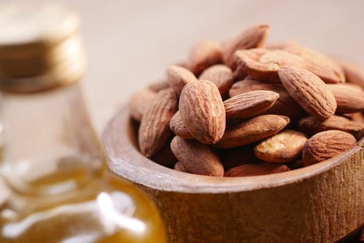 almond oils and fresh nuts on table ,