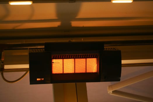 Modern electric infrared heater on celling .