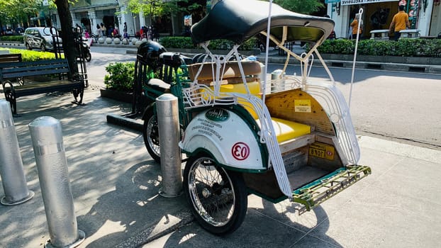 pedicab or rickshaw or locals calls it becak with a canopy is parked on a sunny street, reflecting a vibrant urban scene. The vehicle features a padded seat and unique design