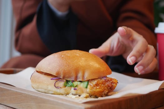 Enjoy a crispy chicken sandwich topped with fresh ingredients, ideal for a quick and tasty bite