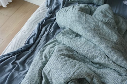 messy bed in early morning , messy bed after waking up .