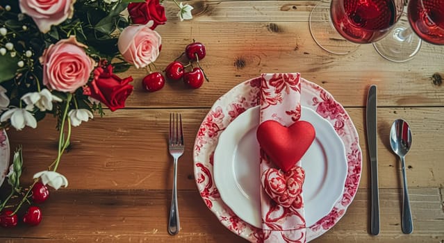 Festive table setting with candles and arrangement of beautiful red flowers. Holiday concept. High quality photo