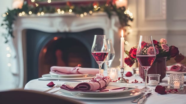 Festive table setting with candles and arrangement of beautiful red flowers. Holiday concept. High quality photo