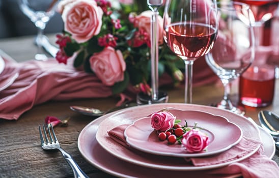 Festive table setting with candles and arrangement of beautiful red flowers. Holiday concept. High quality photo