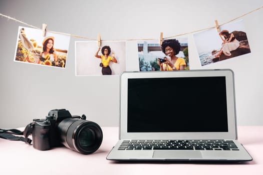 Laptop and camera on the table close up. Printing photos concept