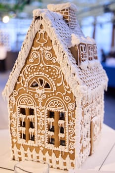 A beautifully crafted gingerbread house, adorned with icing and festive designs, perfect for winter holidays.