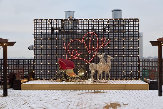 Enjoy a festive rooftop display with a decorated sleigh and dazzling lights, creating a magical winter ambiance