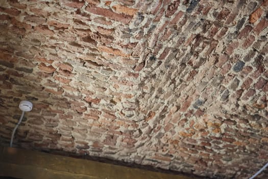 The rustic brick ceiling showcases intricate textures and beautiful tones in a captivating historical setting