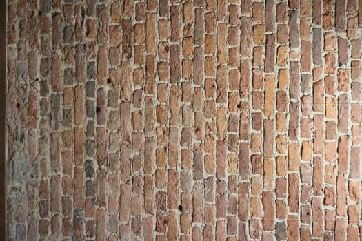 A closeup of a rustic brick wall with varied textures and rich colors, perfect for interior design projects