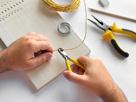 Crafting with precision. Hand tools and wire for diy projects.