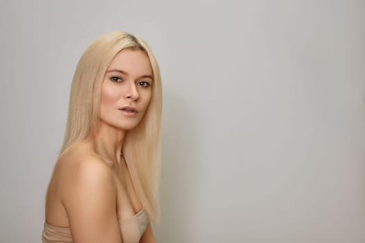 Woman with Straight Blond Hair. Keratin Treatment for Gloss Straight Hair. Bleaching and Toning